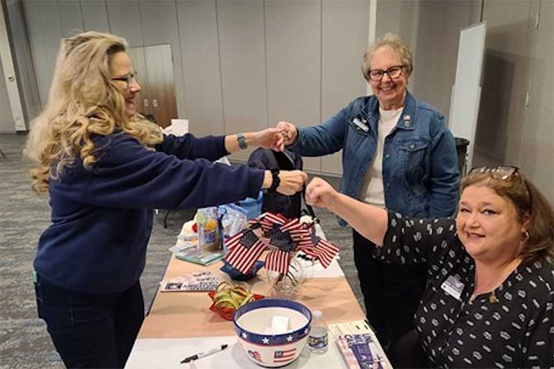ASCNN members fist bumping at table